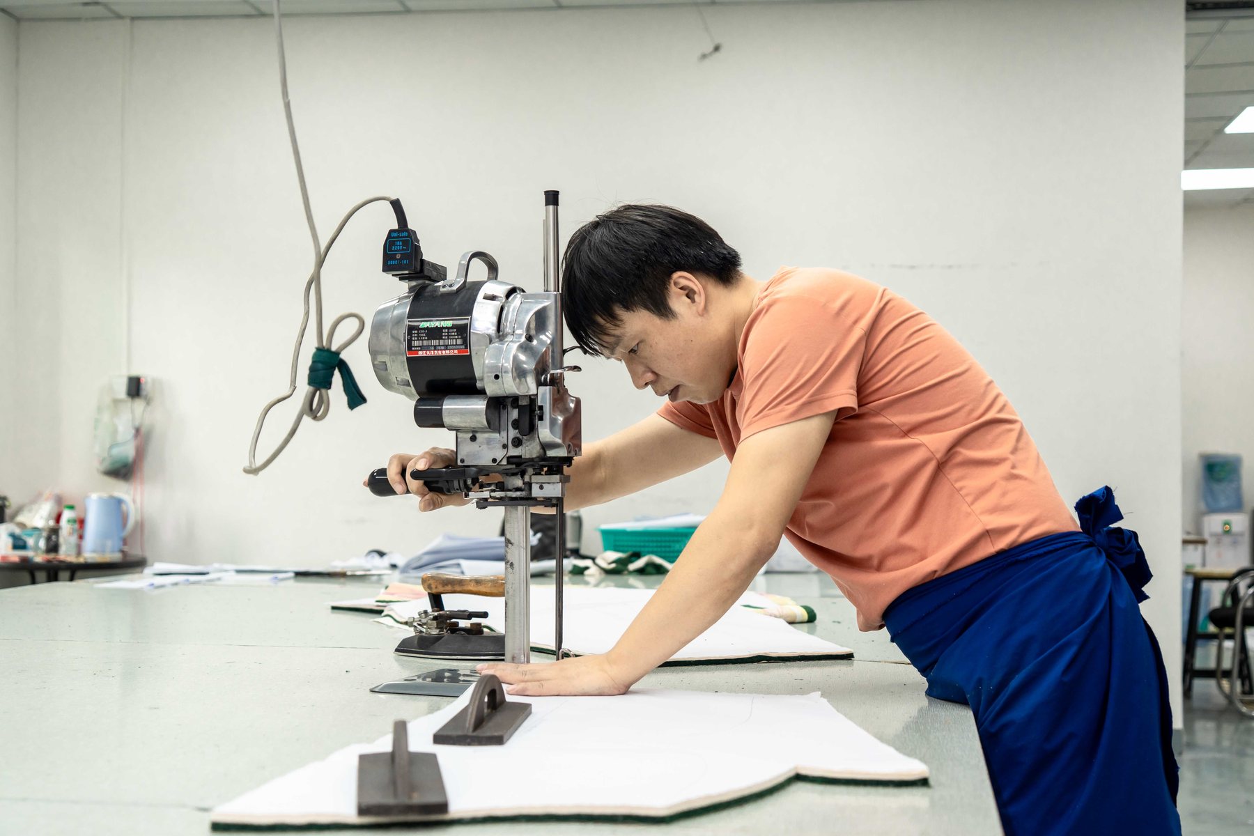 Fabric cutting and preparation at a sportswear cutting table