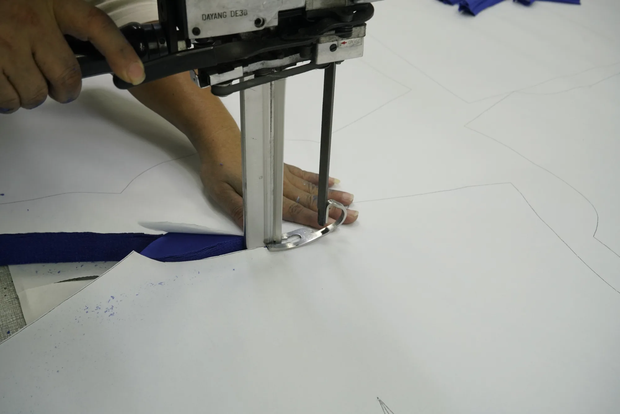 Fabric cutting during custom teamwear production at Eking Sports