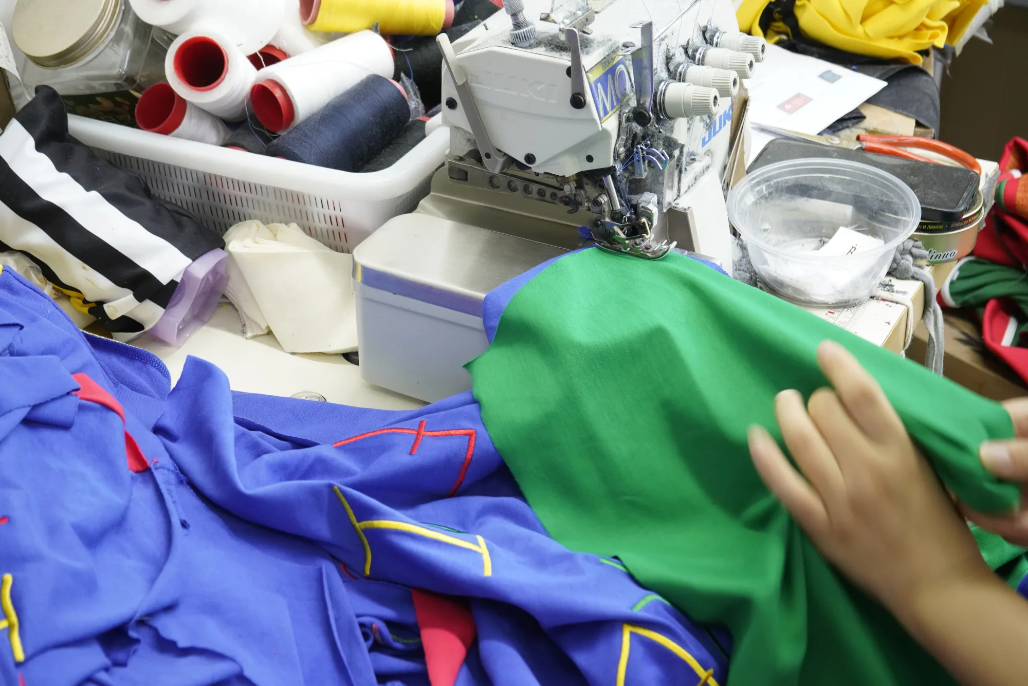 Overlock sewing detail during custom teamwear garment assembly